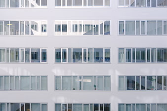 Modern white apartment building facade with grid of windows