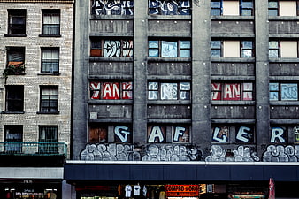 Urban graffiti art on concrete building facade with windows