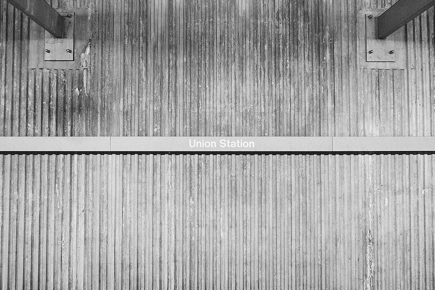 Black and white Union Station sign on corrugated metal wall