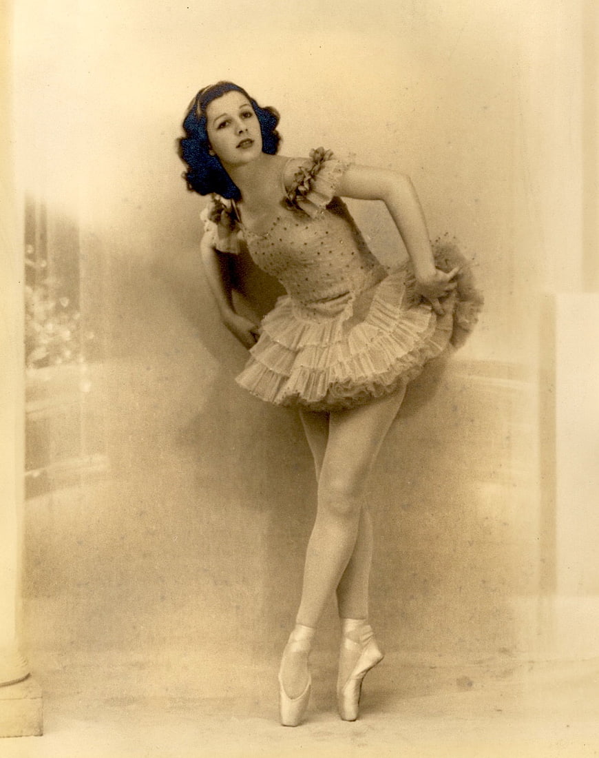 Vintage sepia portrait of a ballerina in a ruffled costume