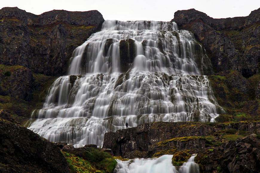Majestic Tiered Waterfall in Rugged Mountain Landscape