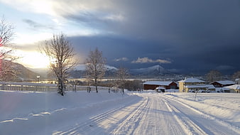 Snowy Road in Scandinavian Winter Landscape with Mountains