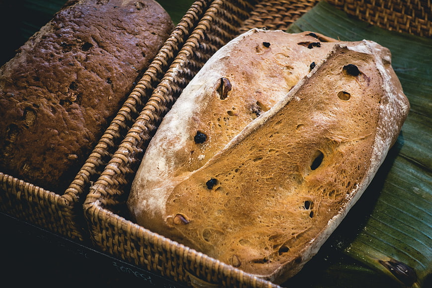 Artisanal sourdough loaves in woven baskets