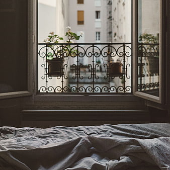 Cozy Bedroom Window View with Wrought Iron Balcony