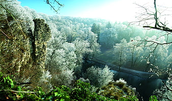 Frosty Winter Forest Landscape with River and Rock Formation