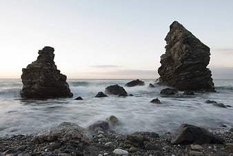 Dramatic Sea Stacks on Rocky Shore at Sunset