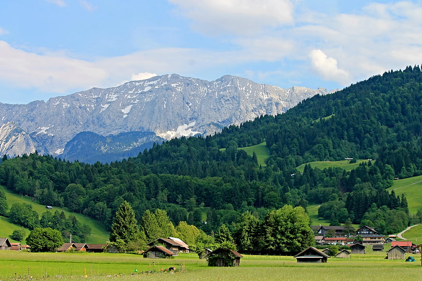 Scenic Alpine Landscape with Green Hills and Snowy Mountains