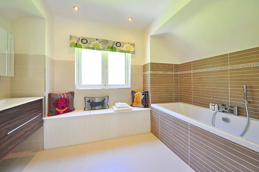Modern bathroom interior with bathtub and window seat