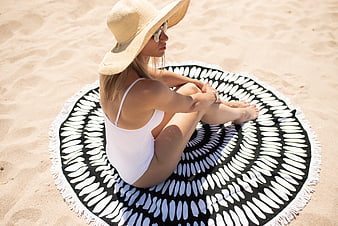 Woman in White Swimsuit Sitting on Round Beach Towel