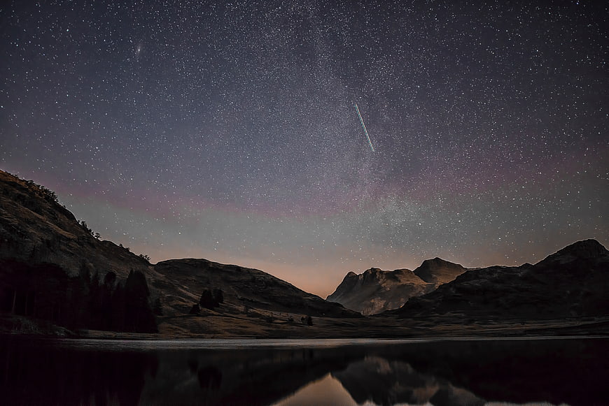 Shooting Star Over Mountain Lake at Night