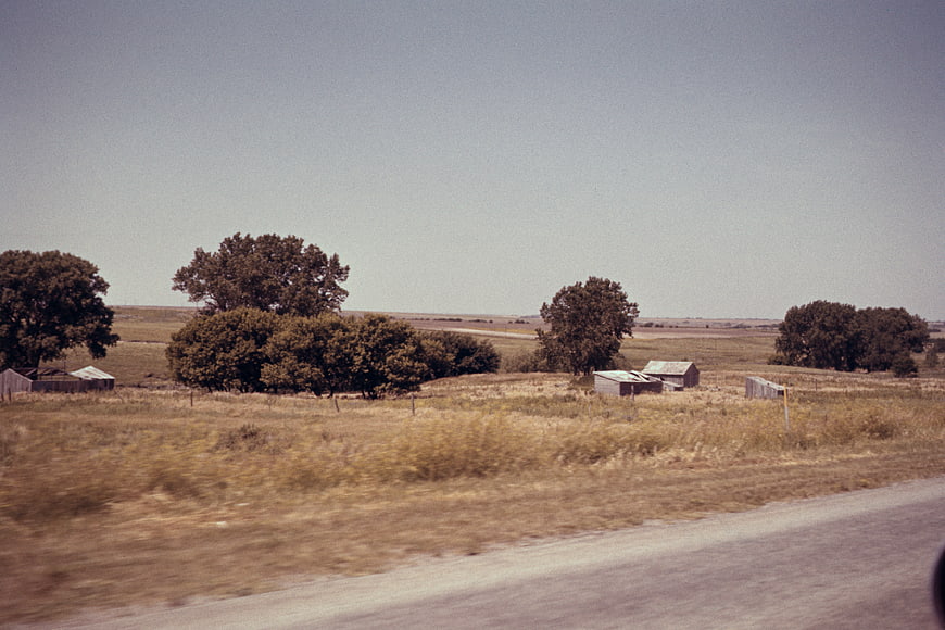 Vintage Film Photograph of Rustic Countryside Barns and Trees