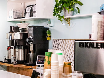 Modern Coffee Shop Counter with Espresso Machine and Cups