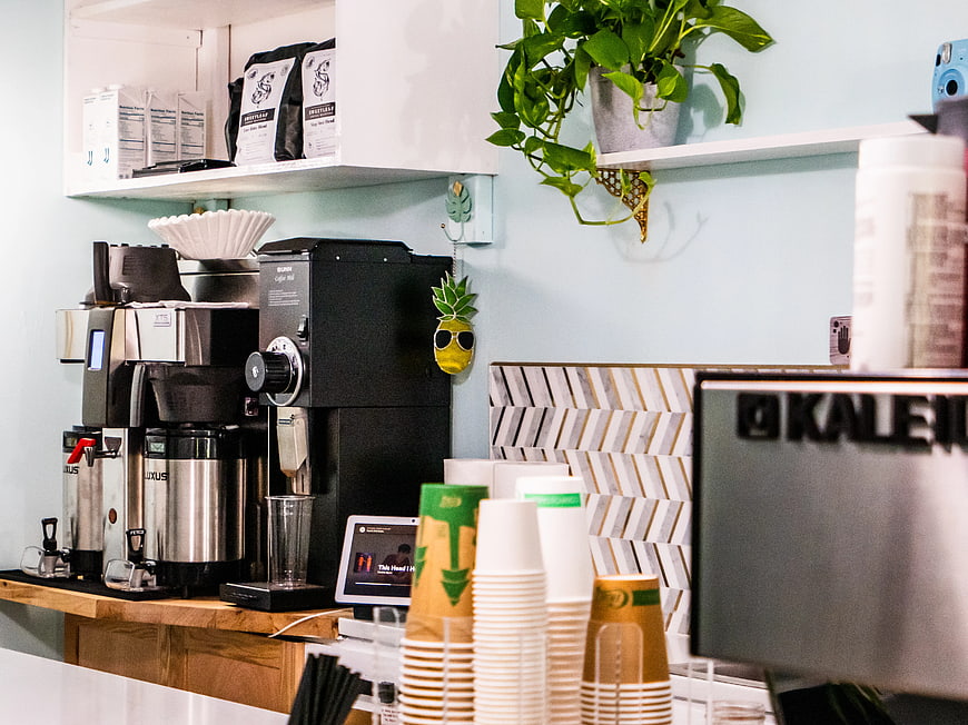 Modern Coffee Shop Counter with Espresso Machine and Cups