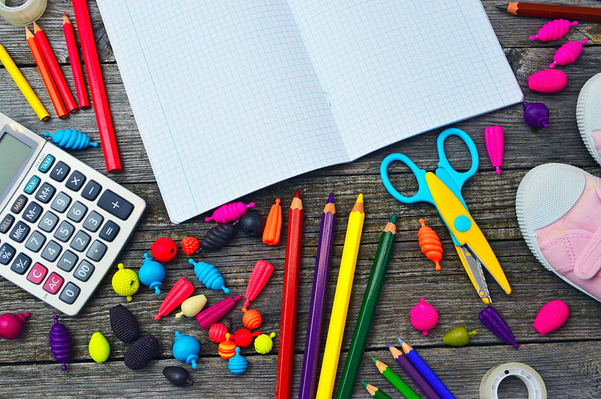 Colorful School Supplies Flat Lay on Rustic Wooden Desk