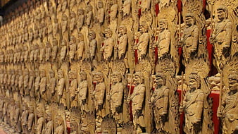 Rows of wooden guardian statues in a Japanese temple