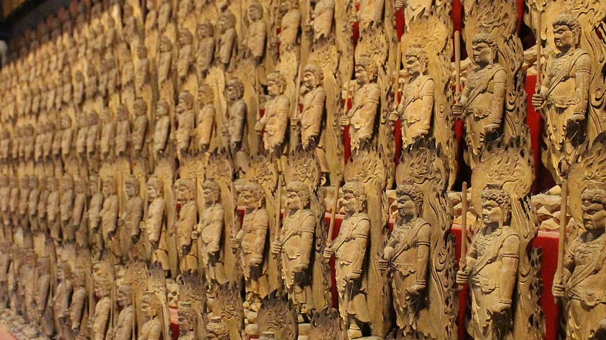 Rows of wooden guardian statues in a Japanese temple