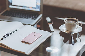 Rose Gold iPhone on Notebook with Coffee and Laptop