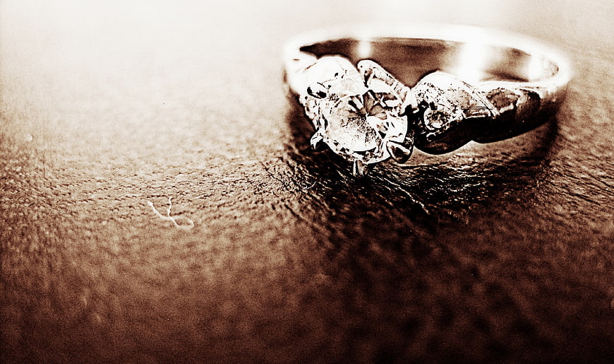 Vintage Sepia Diamond Engagement Ring on Textured Surface