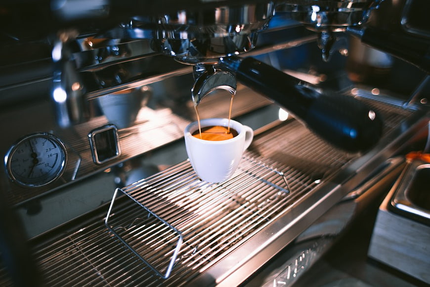 Espresso Pouring from Professional Coffee Machine into White Cup