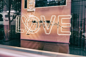 Neon Love Sign in Shop Window Reflection