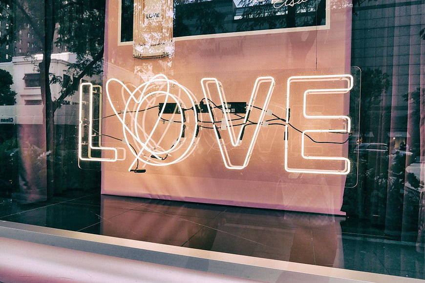 Neon Love Sign in Shop Window Reflection