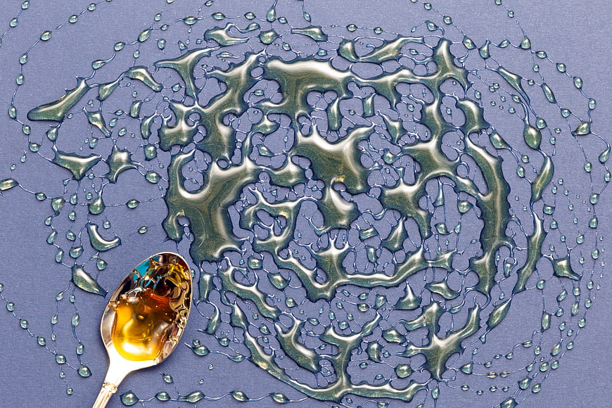 Flat Lay Honey Splash Pattern on Blue Background