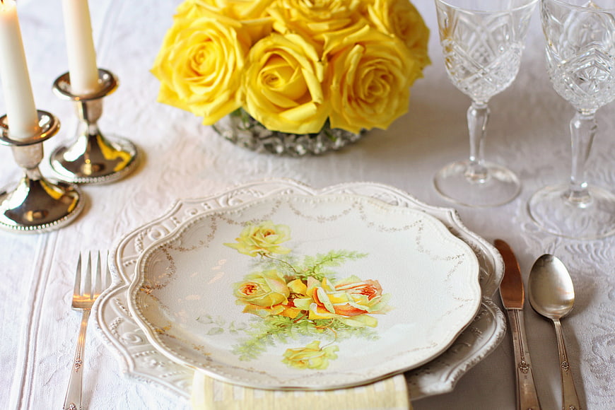 Elegant Vintage Table Setting with Yellow Roses and Silverware