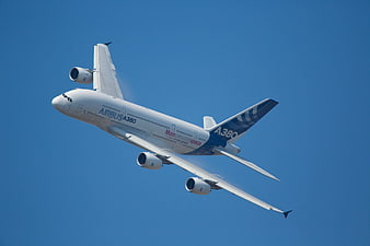 Airbus A380 Passenger Jet Climbing Against Clear Blue Sky