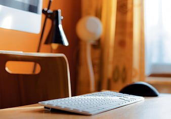 Modern Workspace with White Keyboard and Wooden Desk