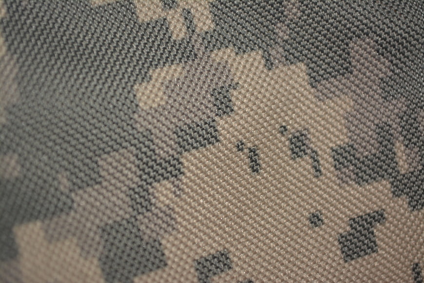 Close-up of ACU digital camouflage fabric texture in gray and tan
