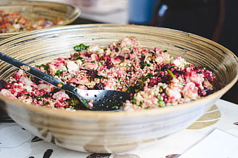 Healthy vegan grain salad with beets and cauliflower in ceramic bowl