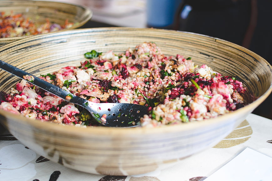 Healthy vegan grain salad with beets and cauliflower in ceramic bowl