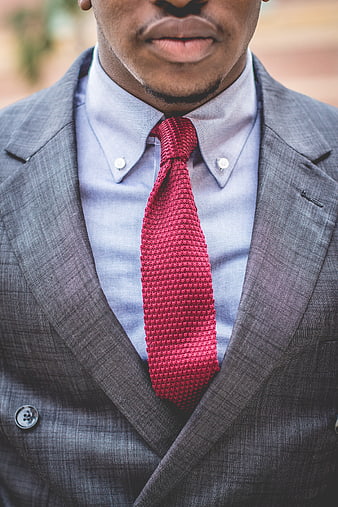 Close-up of man in grey suit with red knitted tie