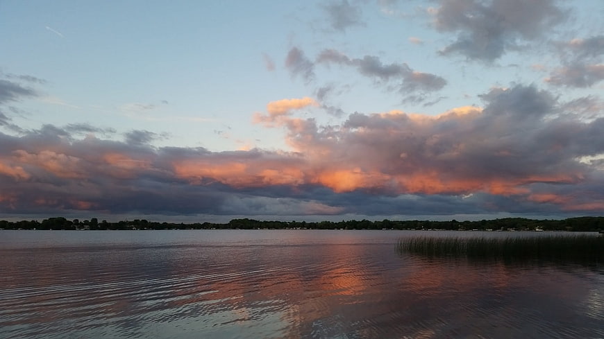 Serene Lake Sunset Landscape With Dramatic Clouds And Water Reflections