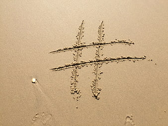 Hashtag Symbol Drawn in Sand on Beach