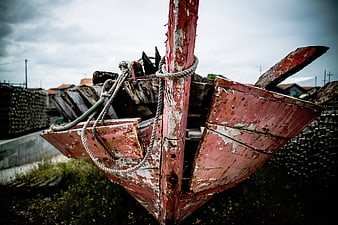 Weathered Red Wooden Fishing Boat on Shore