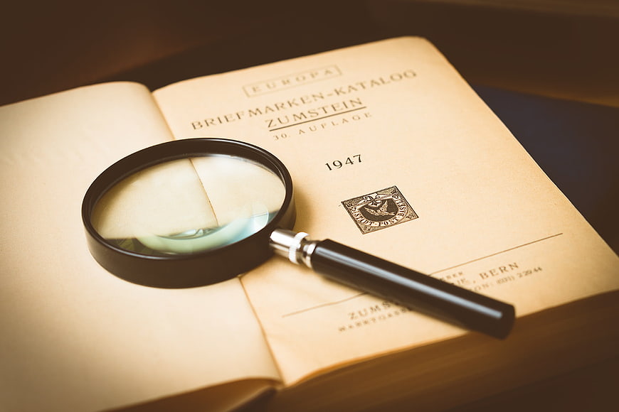 Vintage Stamp Catalog with Magnifying Glass