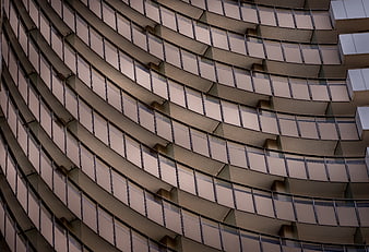 Curved modern building facade with repeating balcony pattern