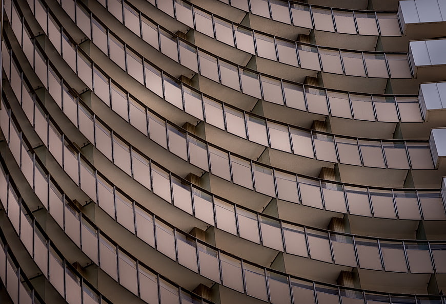 Curved modern building facade with repeating balcony pattern