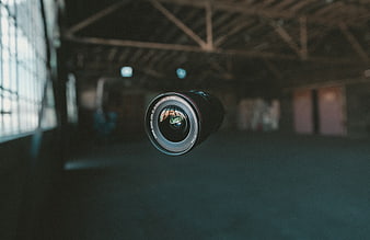Floating camera lens in abandoned industrial warehouse interior