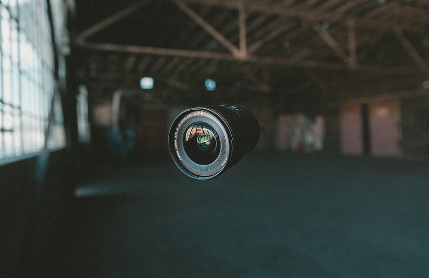 Floating camera lens in abandoned industrial warehouse interior