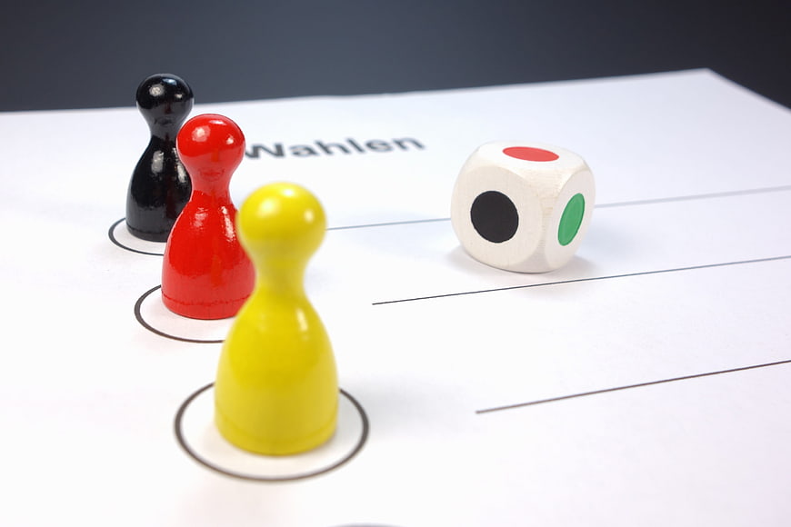 German election concept with game pieces and dice on ballot