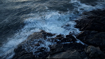 Crashing Ocean Waves on Dark Rocky Coastline
