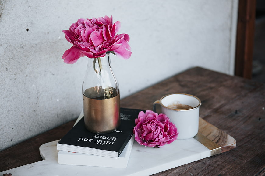 Pink Peonies in Vase with Coffee and Books on Wooden Table