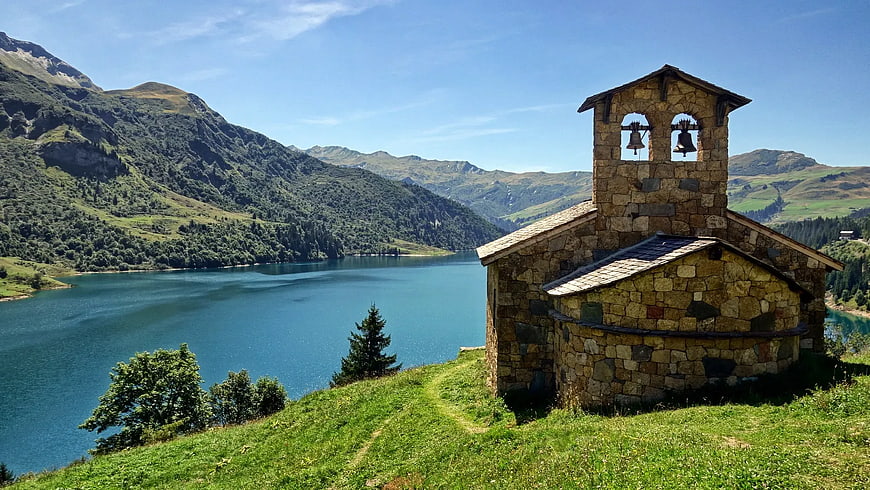 Stone Chapel by Mountain Lake in Summer