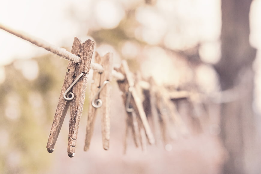 Vintage Wooden Clothespins on a Rope with Blurred Background