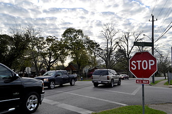 Stop sign at suburban street intersection with trucks