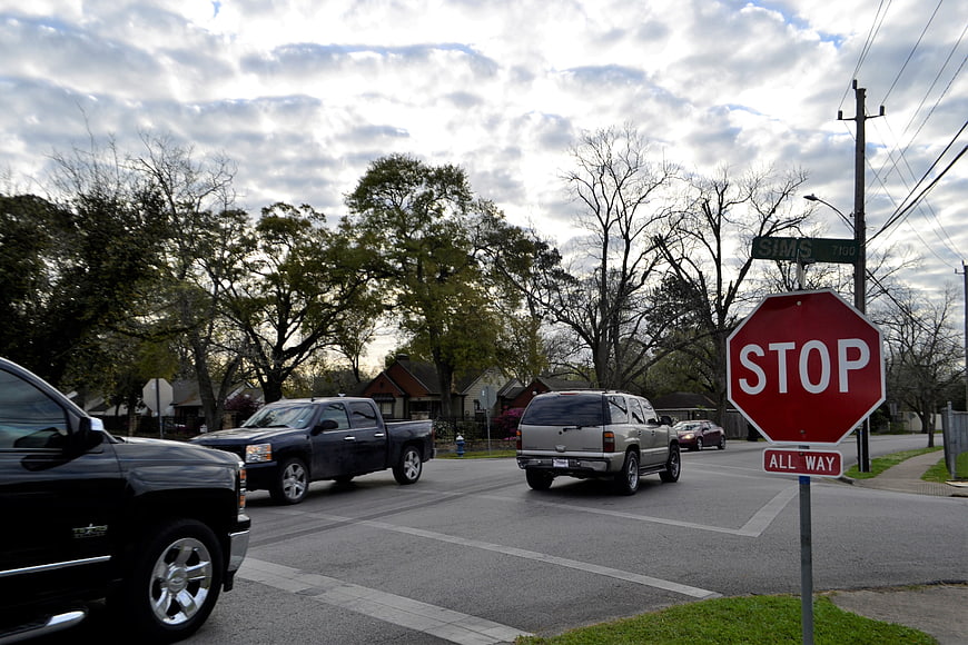 Stop sign at suburban street intersection with trucks