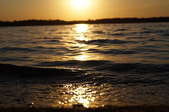 Golden Sunset Reflection on Rippling Lake Water
