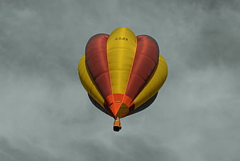 Heart-Shaped Hot Air Balloon Flying in Cloudy Sky